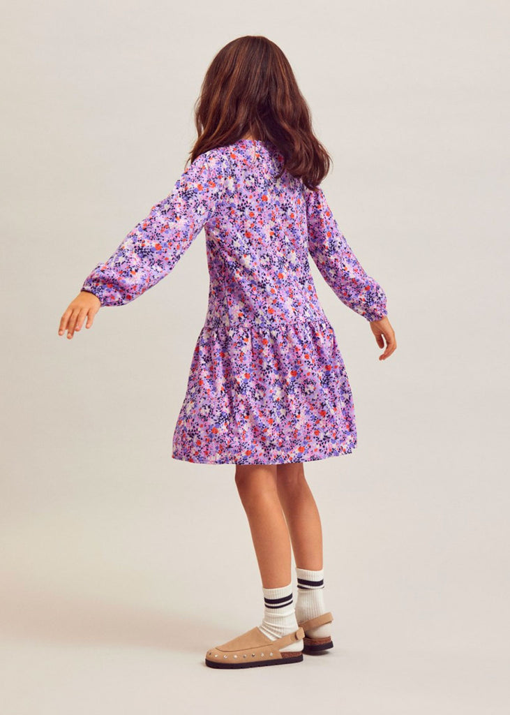 Young girl wearing a floral dress.