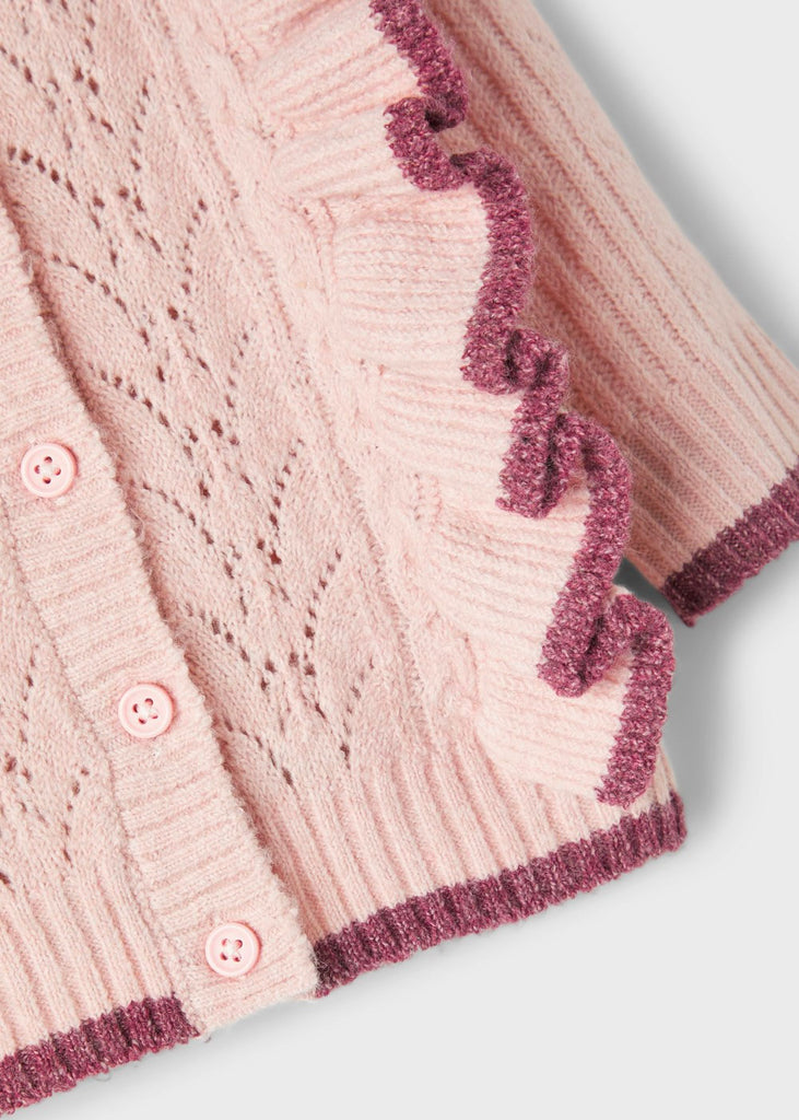 close up of baby cardigan in pink.